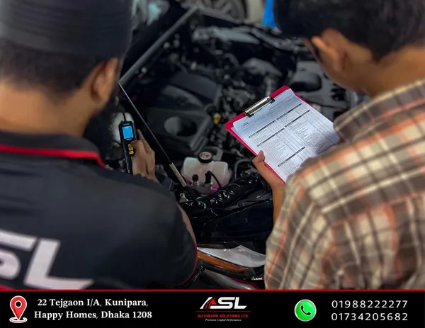 Technicians performing a diagnostic inspection with a checklist at Autobahn Solutions, Dhaka