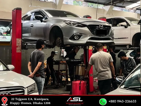 Vehicle raised on a lift for undercarriage service at Autobahn Solutions, Dhaka