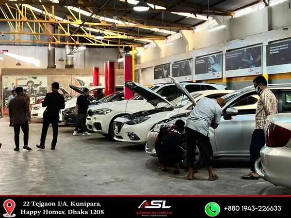 Autobahn Solutions technicians working on cars in the Dhaka workshop