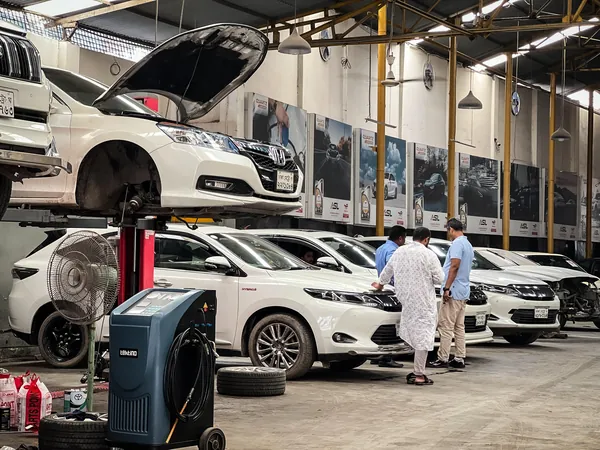 Cars raised on lifts during service at the Autobahn Solutions workshop, Dhaka