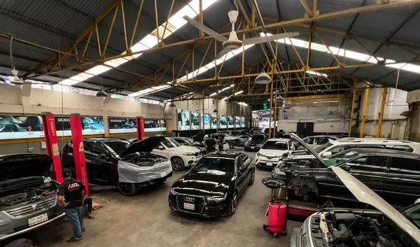 Luxury European cars including an Audi inside the Autobahn Solutions workshop in Tejgaon, Dhaka