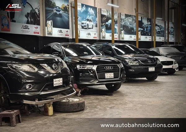 Lineup of luxury SUVs and sedans being serviced at Autobahn Solutions, Dhaka