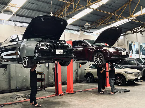 BMW raised on a two-post lift during servicing at Autobahn Solutions, Dhaka