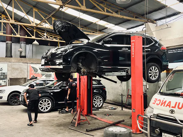 SUV raised on a lift for underbody service at Autobahn Solutions, Dhaka