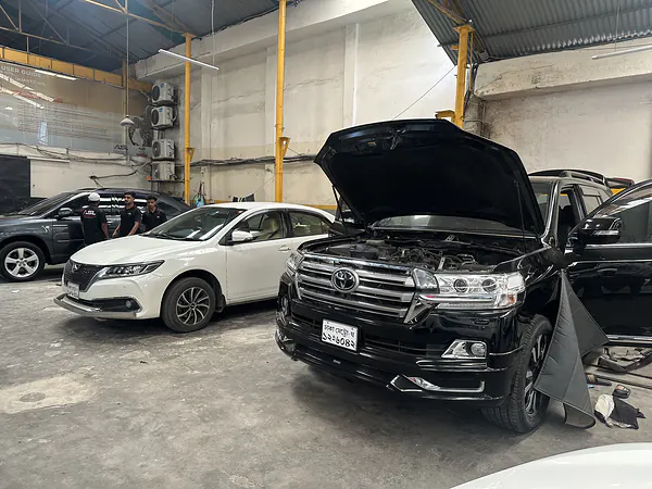 Toyota Land Cruiser with the bonnet open at the Autobahn Solutions workshop, Dhaka