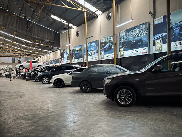 Service bays and vehicles inside the Autobahn Solutions workshop in Tejgaon, Dhaka