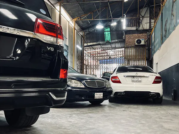 Vehicles lined up for service inside the Autobahn Solutions workshop, Dhaka