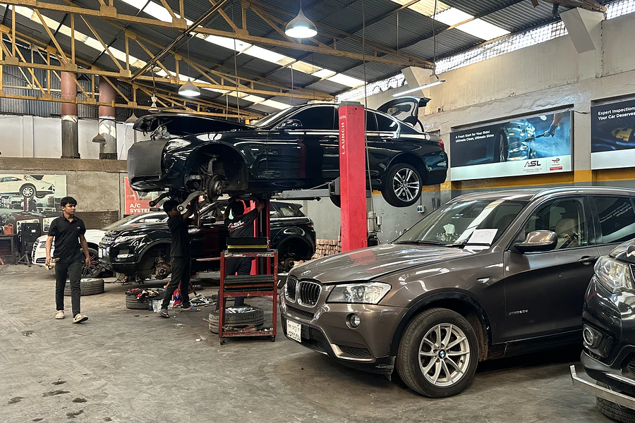 BMW SUV being serviced alongside other vehicles in the Autobahn Solutions workshop