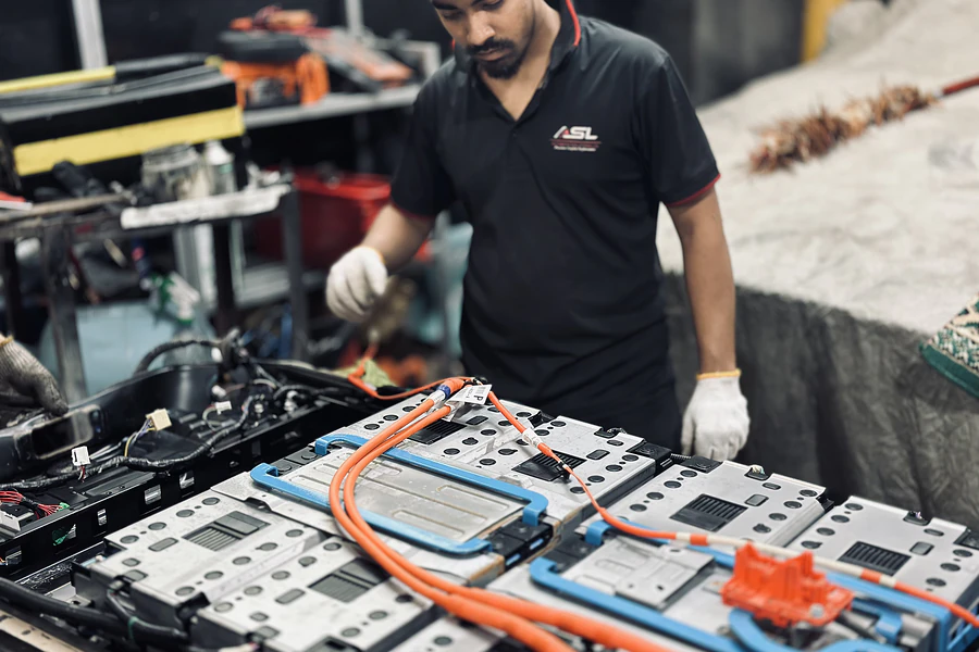 Autobahn Solutions technician servicing a disassembled hybrid battery pack